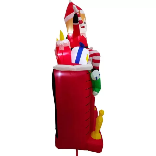 Fraser Hill Farm 6.5 ft. Pre-Lit Elf Sitting on a Fireplace Christmas Inflatable
